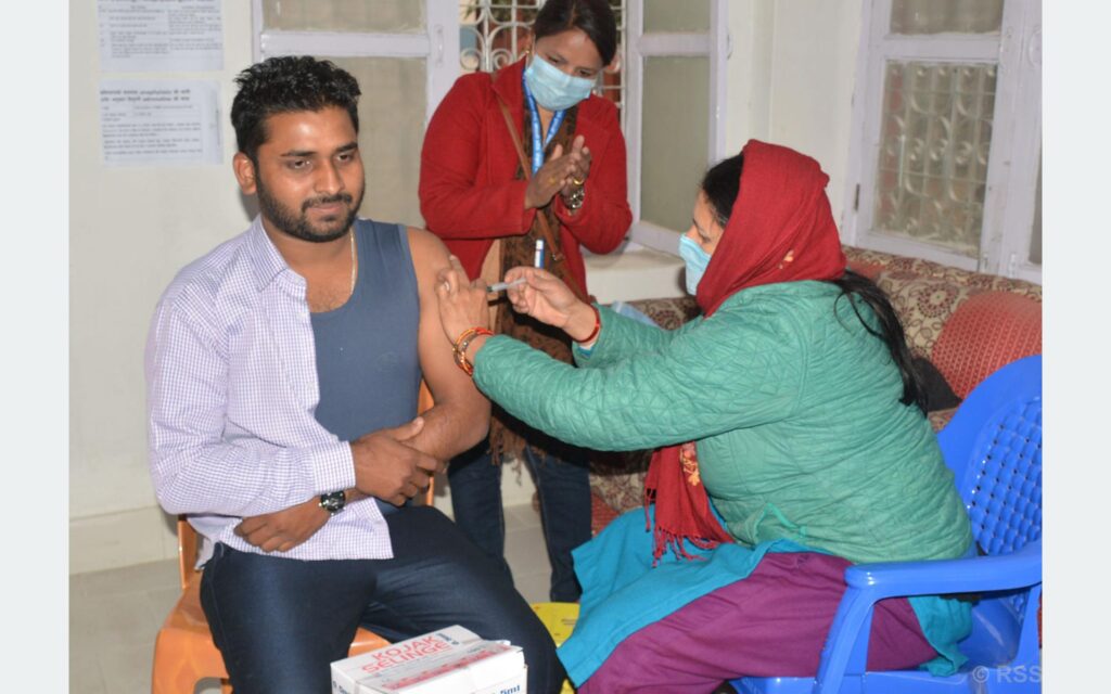Nepali Health Worker Taking Vaccine